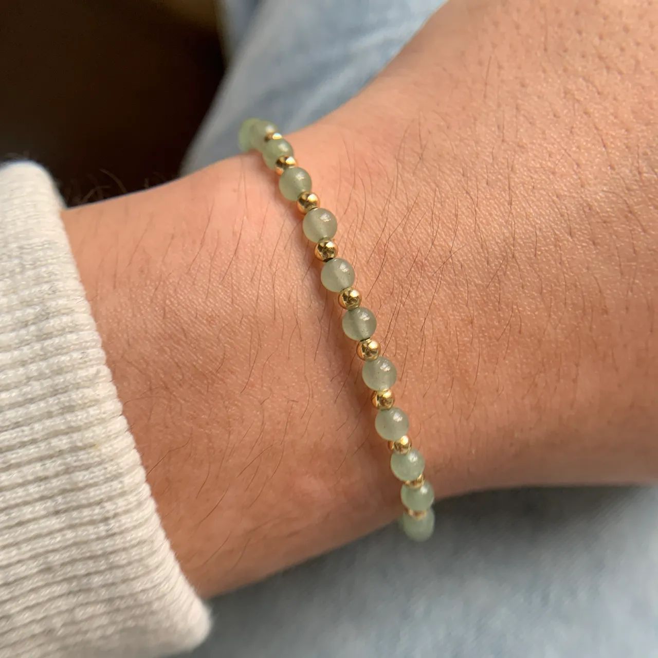 Wearing a Green Aventurine Bracelet on the arm, it glows in the glow of the sunset