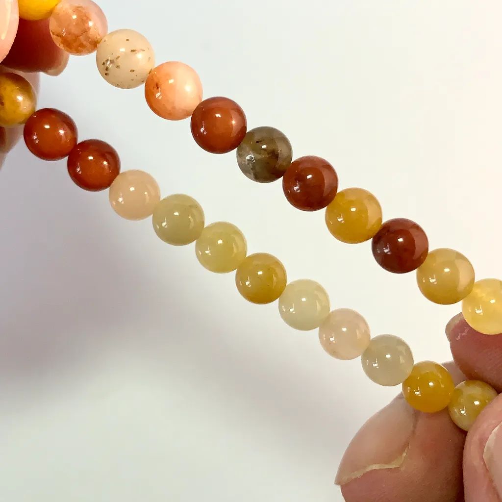 Close-up of Golden Silk Jade beads showing natural golden threads