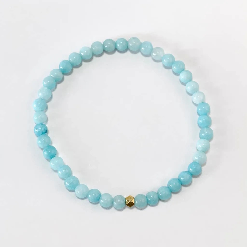 Aquamarine bracelet — front view, translucent blue aquamarine beads on white background