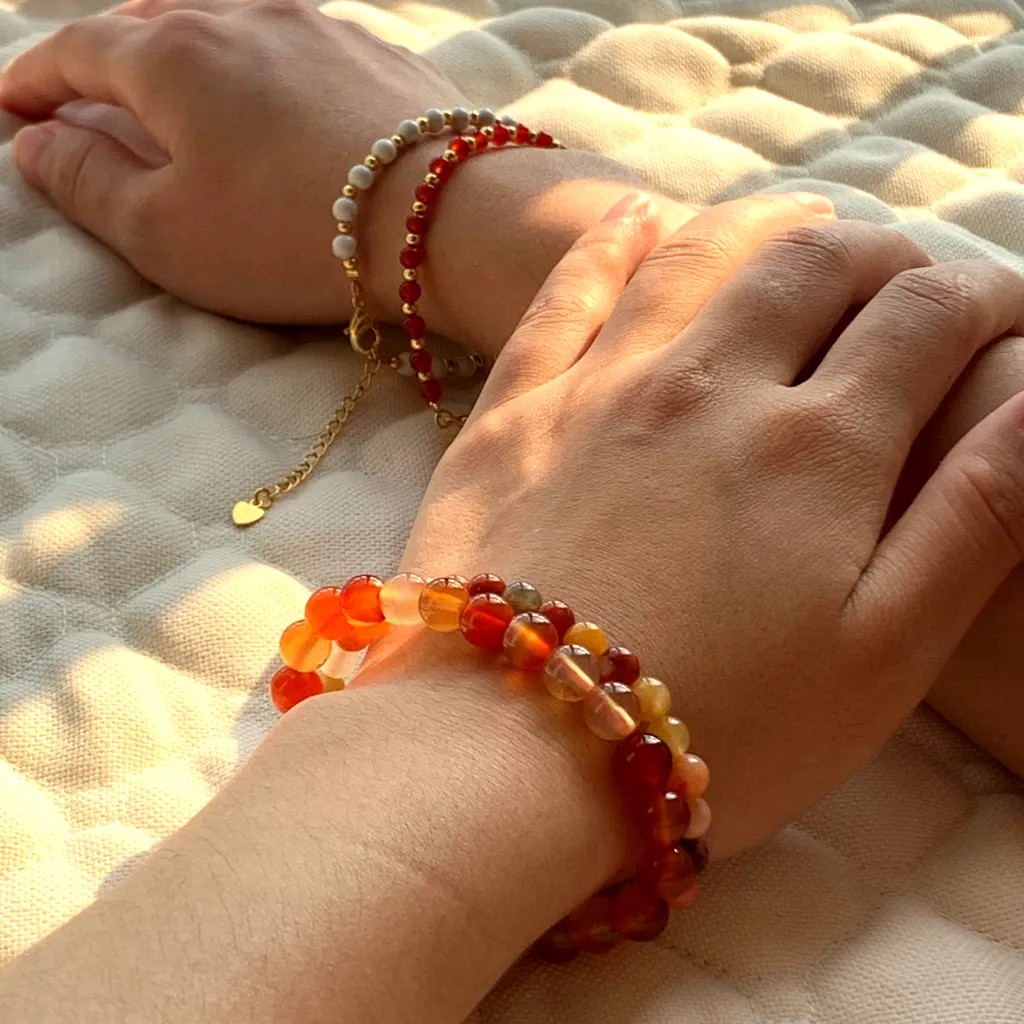 Carnelian bracelet layered with Howlite Bracelet on the wrist — a stacked everyday styling