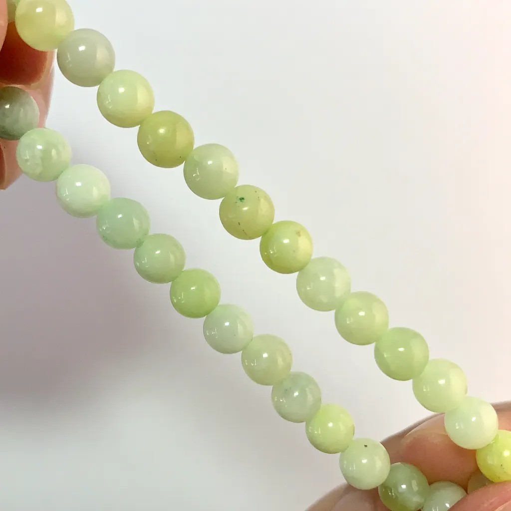 Close-up of New Mountain Jade beads and elastic cord
