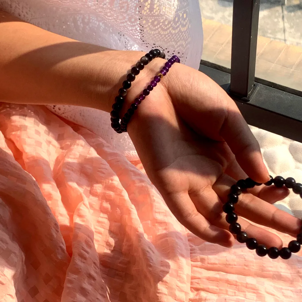 Obsidian Bracelet layered with amethyst bracelet on the wrist — a stacked everyday styling